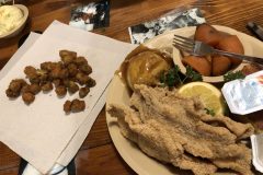 Catfish with candied yams, mashed potatoes, and fried okra.