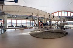 A model of the Wright Flyer with preserved artifacts from the original aircraft displayed around it